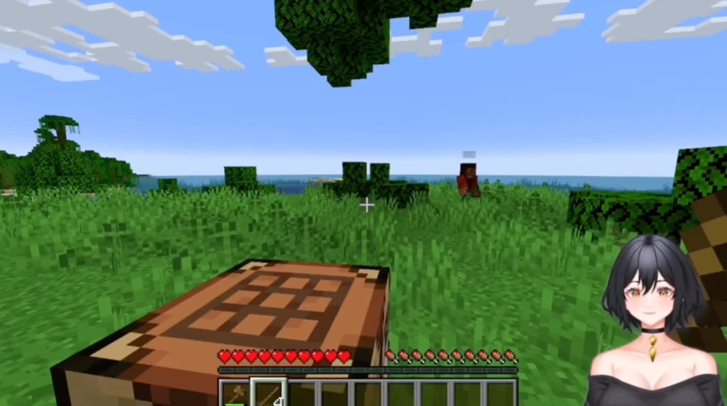 Minecraft in bright daylight: a crafting table in a grass field with a villager in the distance, and Maya overlaid in the bottom right corner, watching.